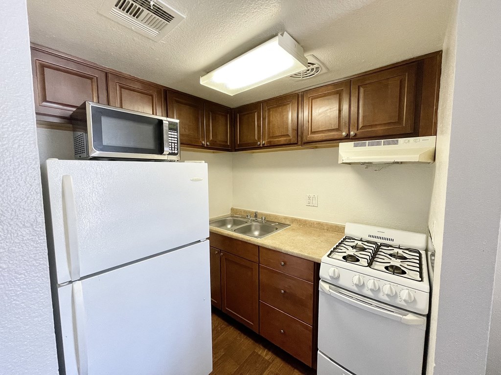 a kitchen with a stove microwave and refrigerator