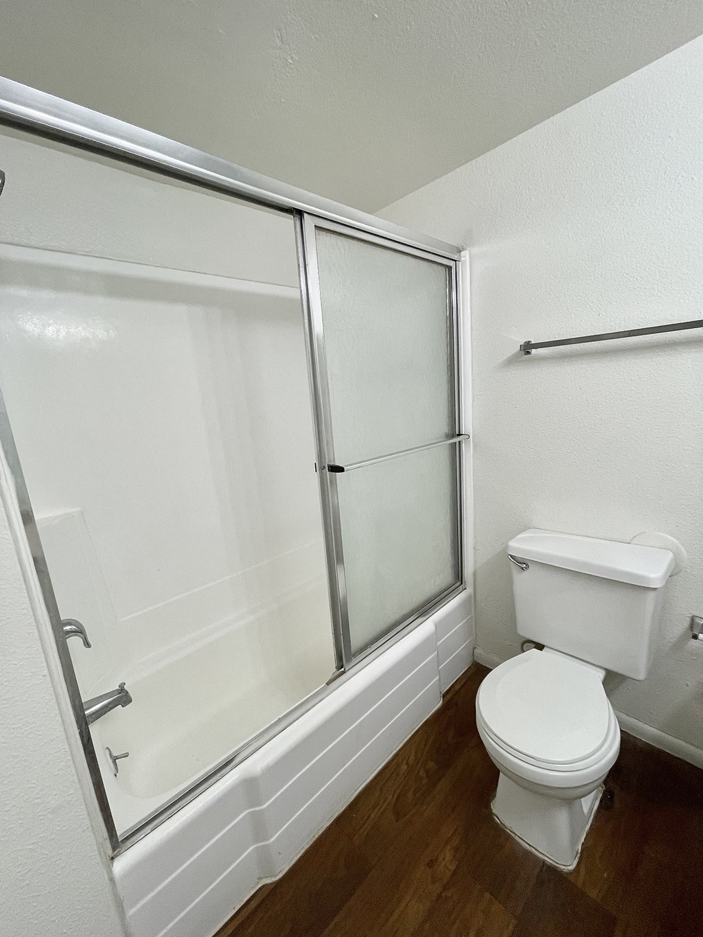 an empty bathroom with a toilet and a shower