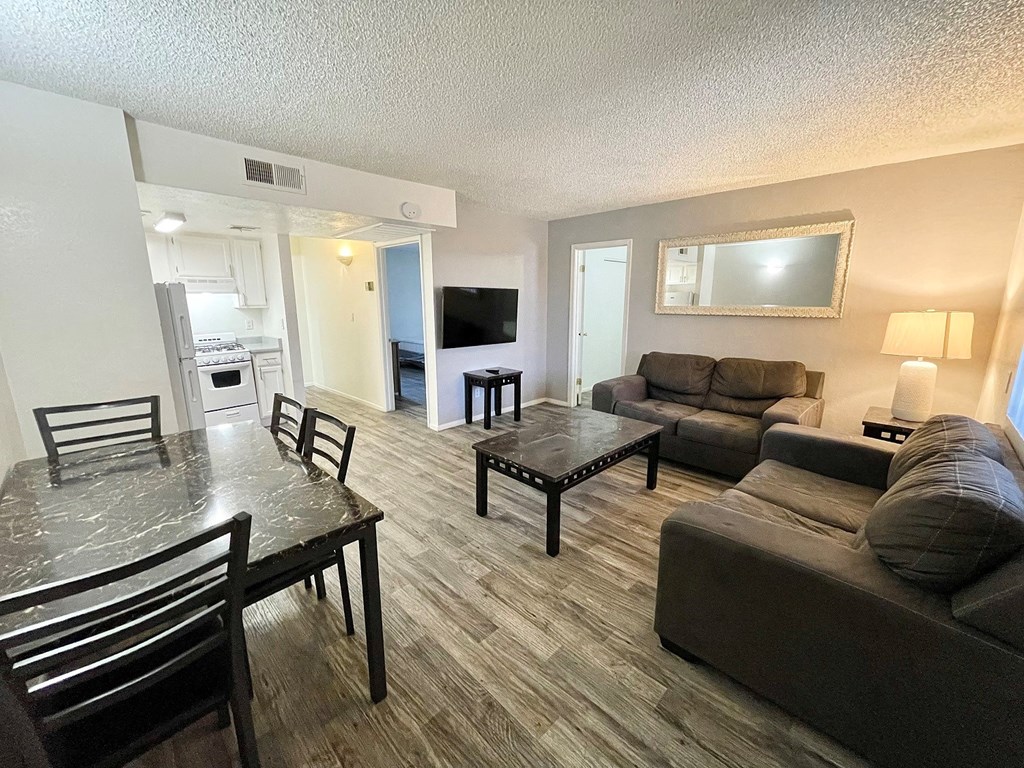 a living room and dining room with a couch and a table