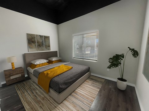 a bedroom with a bed and a potted plant