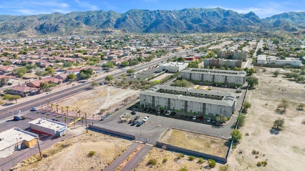 an aerial view of a city with mountains in the background
