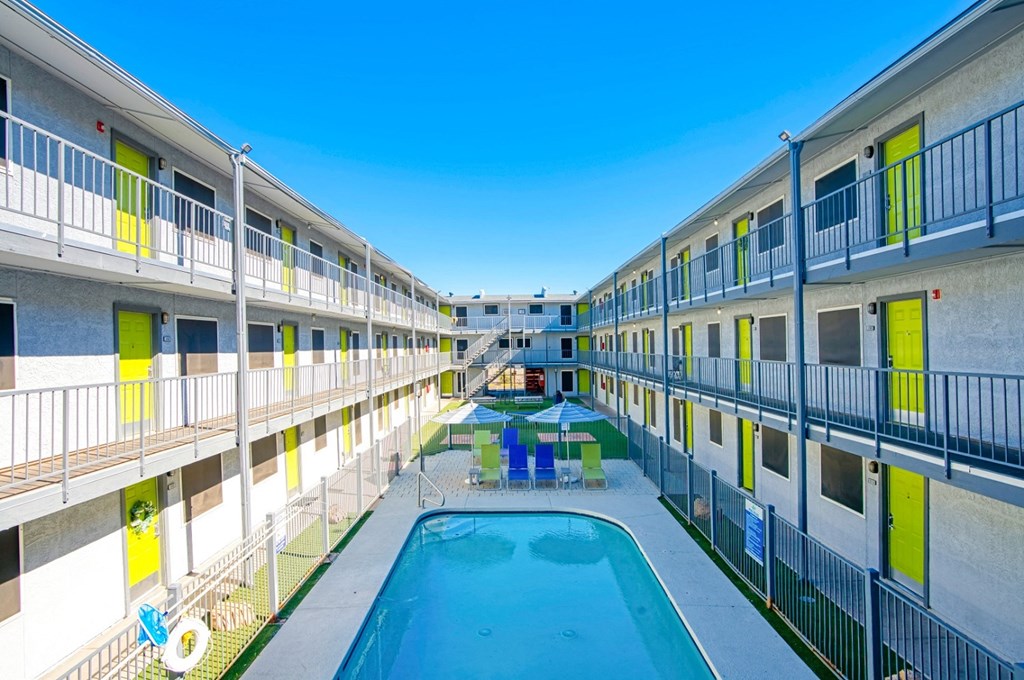 a courtyard with a pool and a building with balconies