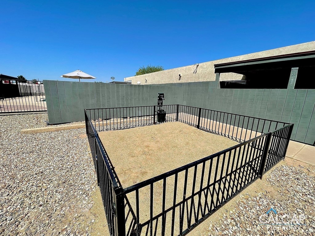 a yard with a fence and a fire hydrant