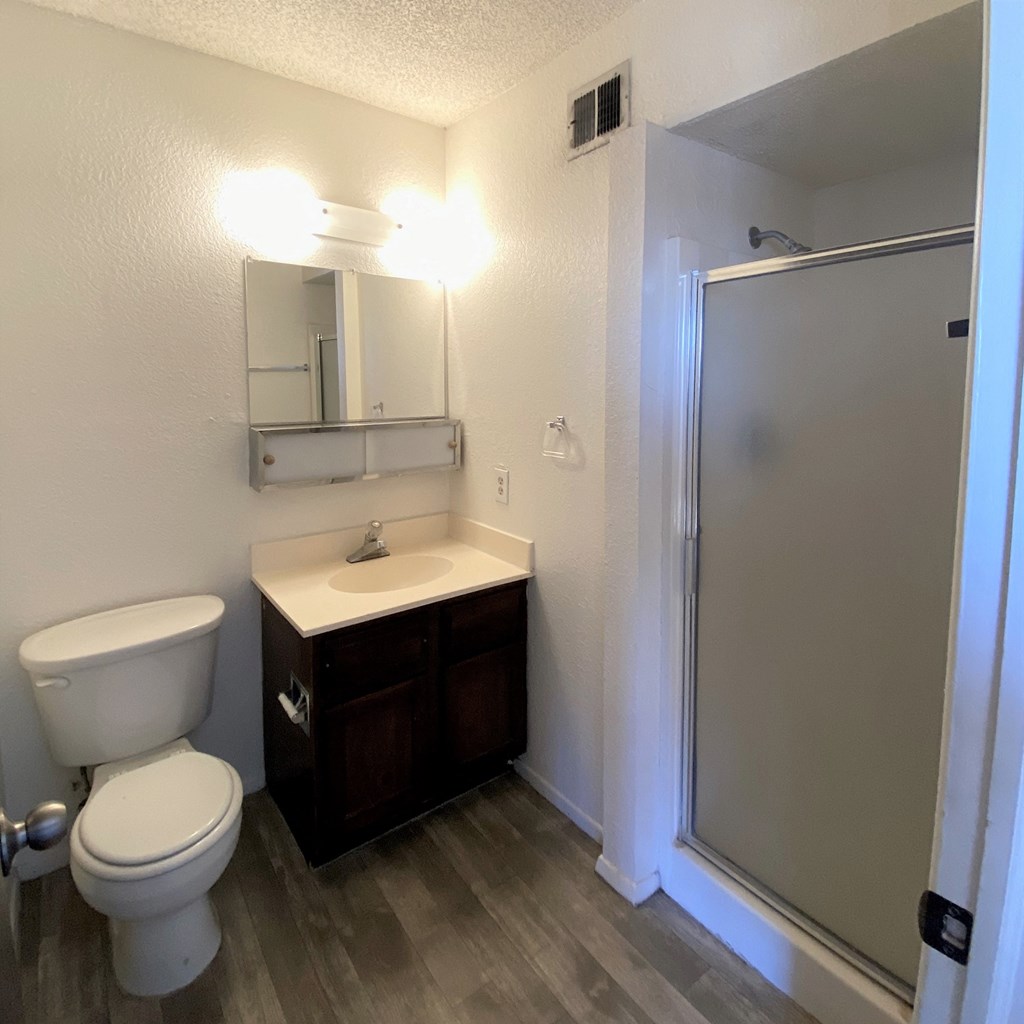 a bathroom with a toilet sink and shower