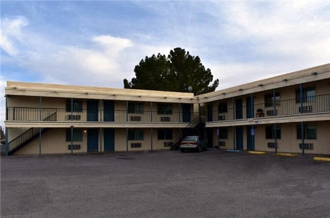 a motel building with a car parked in front of it