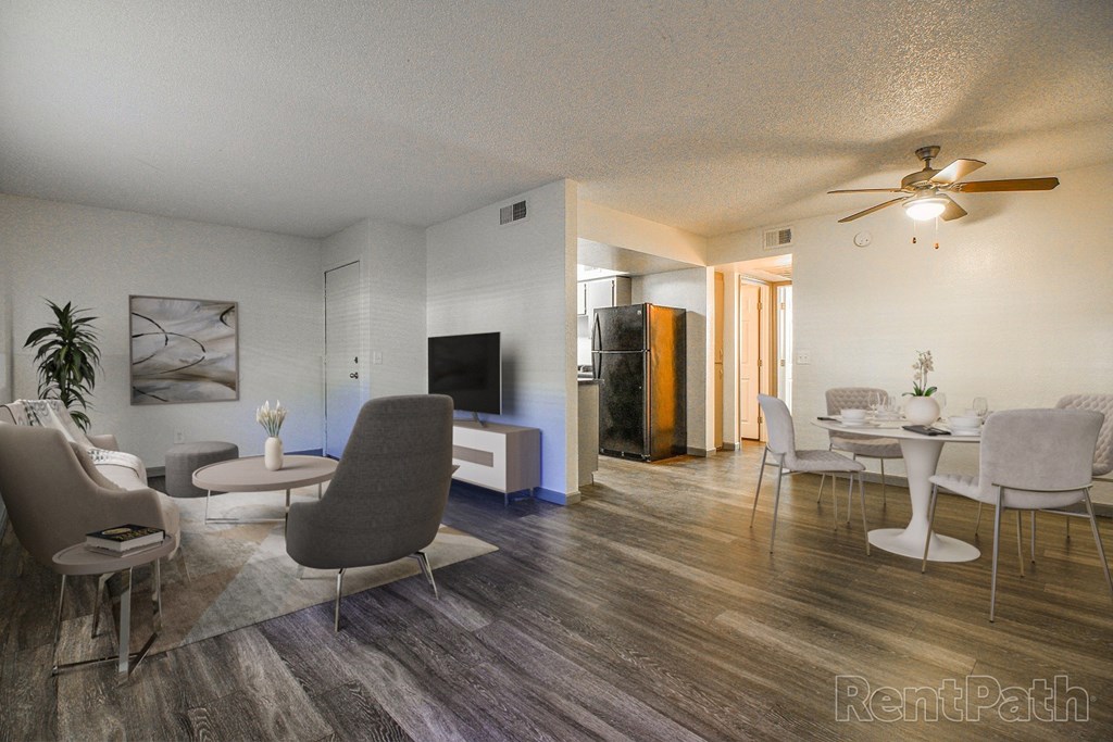 A living room with a grey sofa and a wooden floor.
