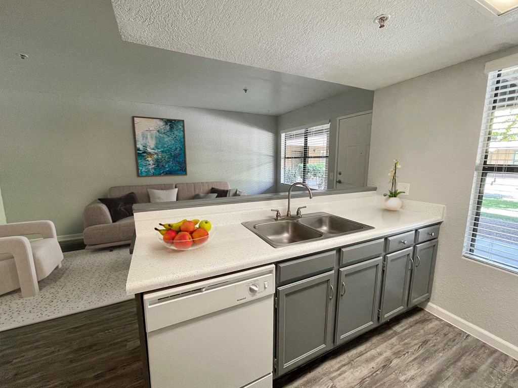 an open kitchen and living room with a sink