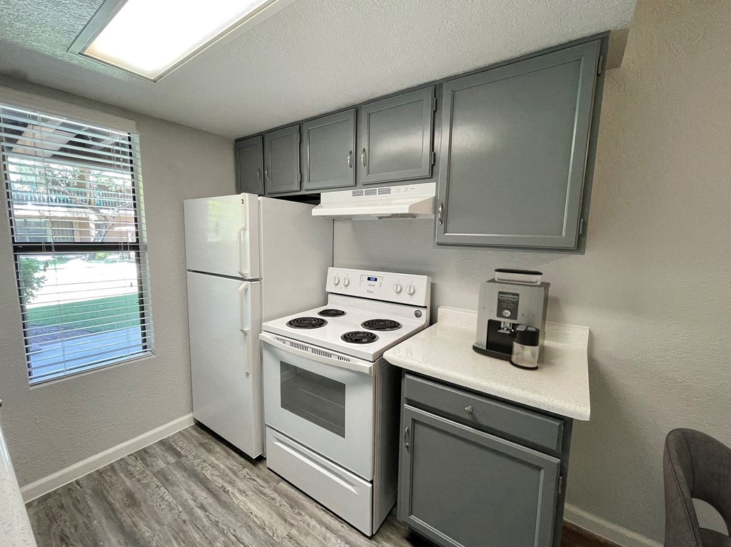 a kitchen with a stove and a refrigerator