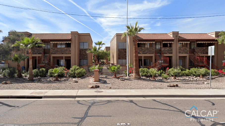 a street view of a building with palm trees