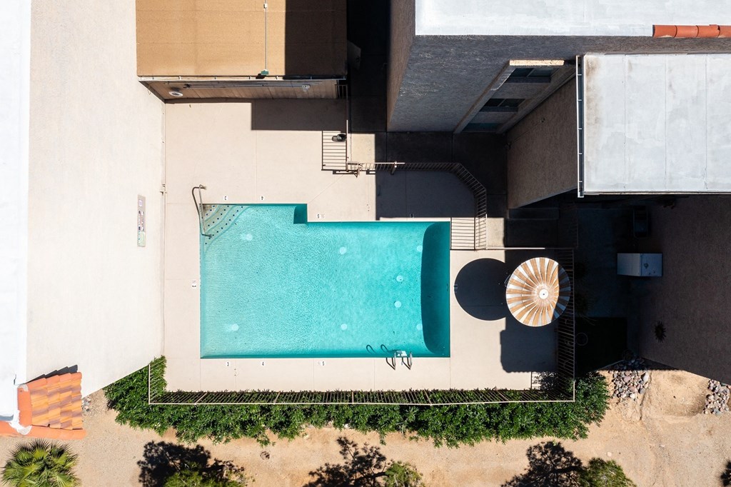 an aerial view of a swimming pool and a building with a pool
