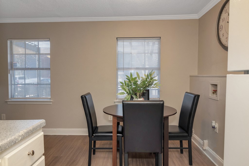 an image of a dining room with a table and chairs