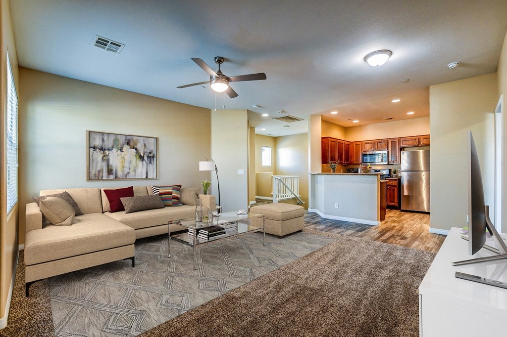 a living room with a couch and a kitchen