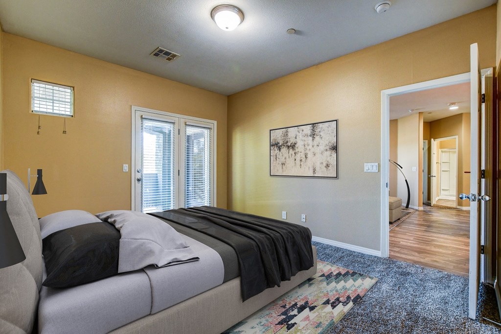 a bedroom with a bed and a door to a bathroom