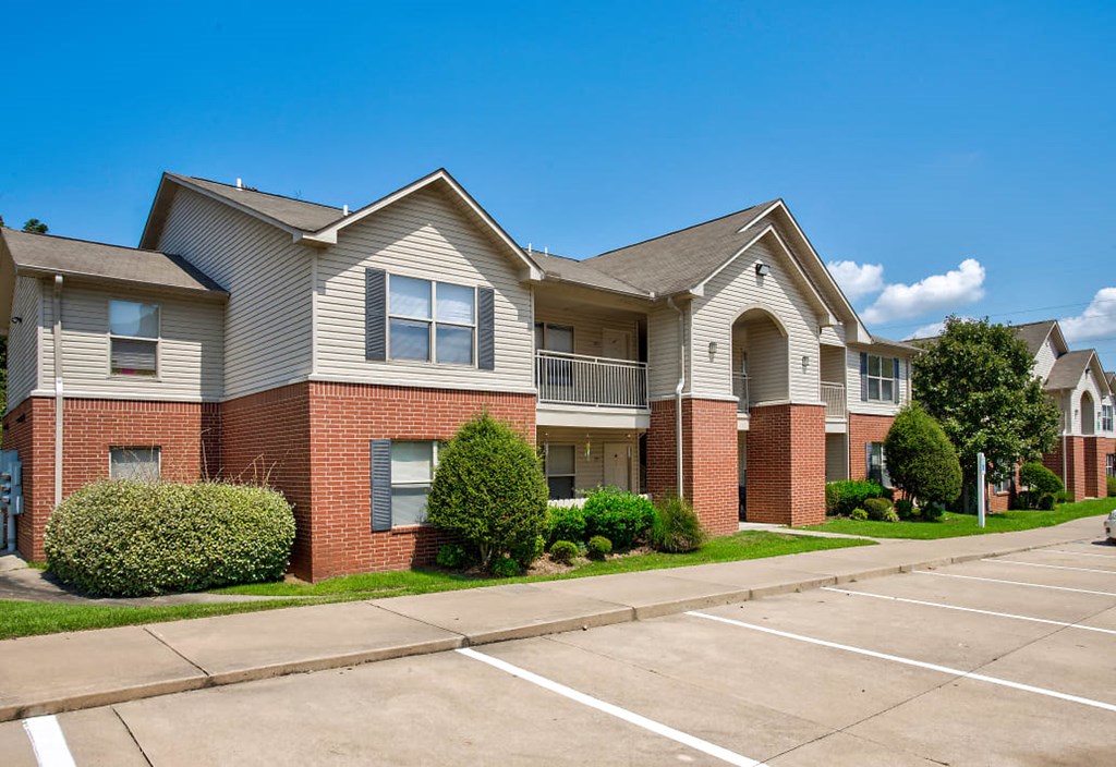 an empty parking lot in front of an apartment building