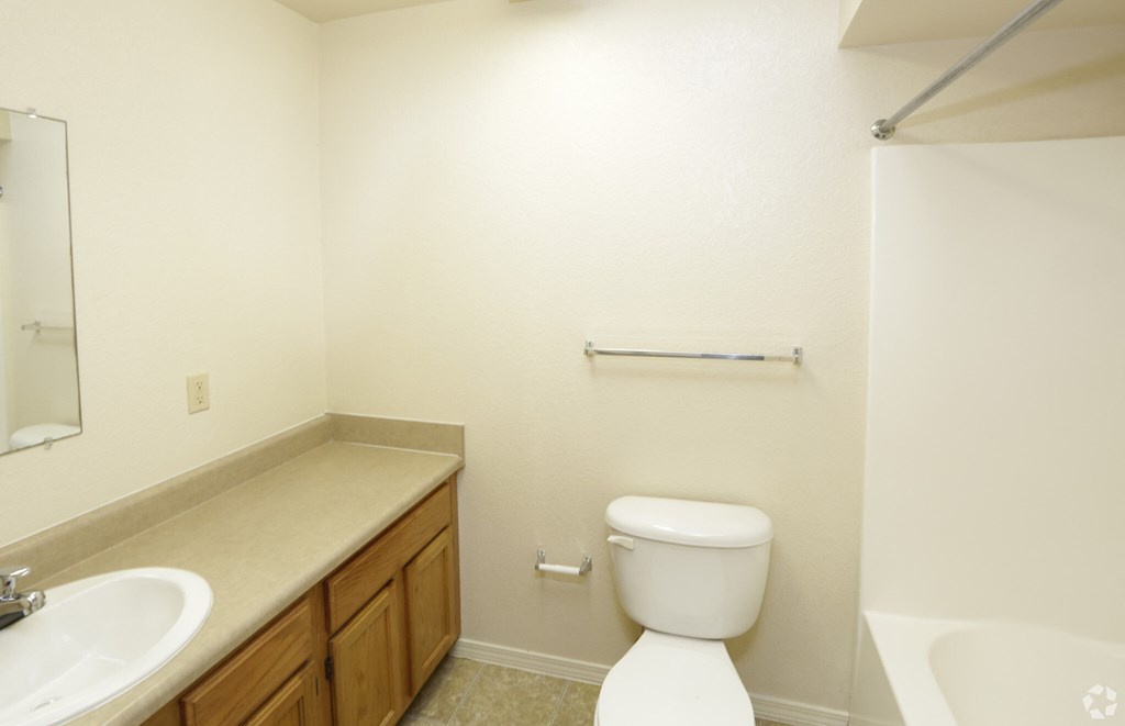 an empty bathroom with a toilet and a sink
