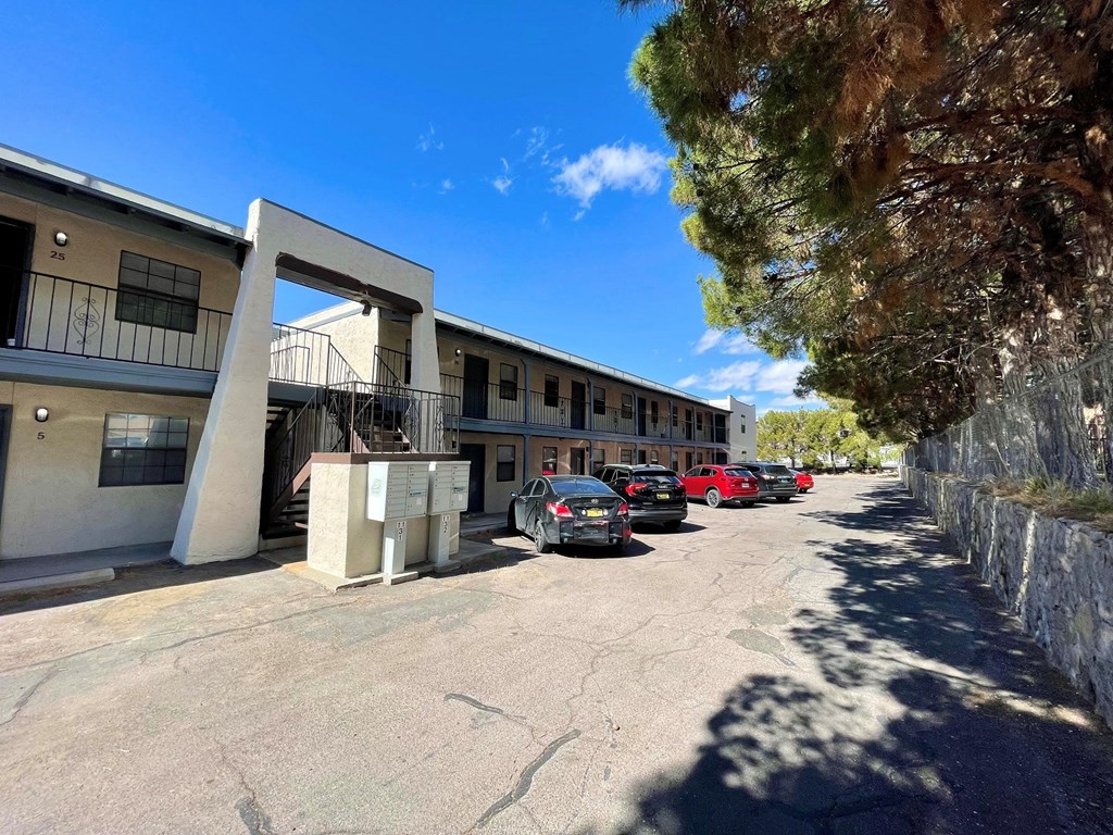 an apartment building with cars parked in front of it