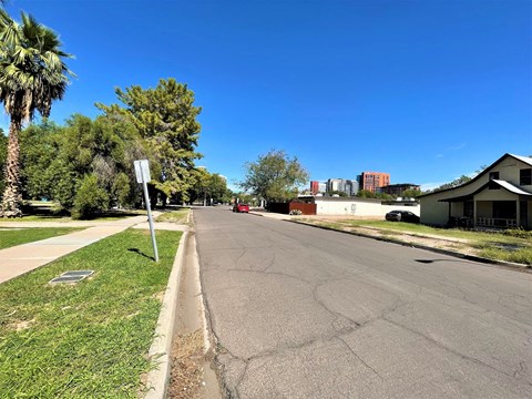 a street with houses and trees on the side of a road