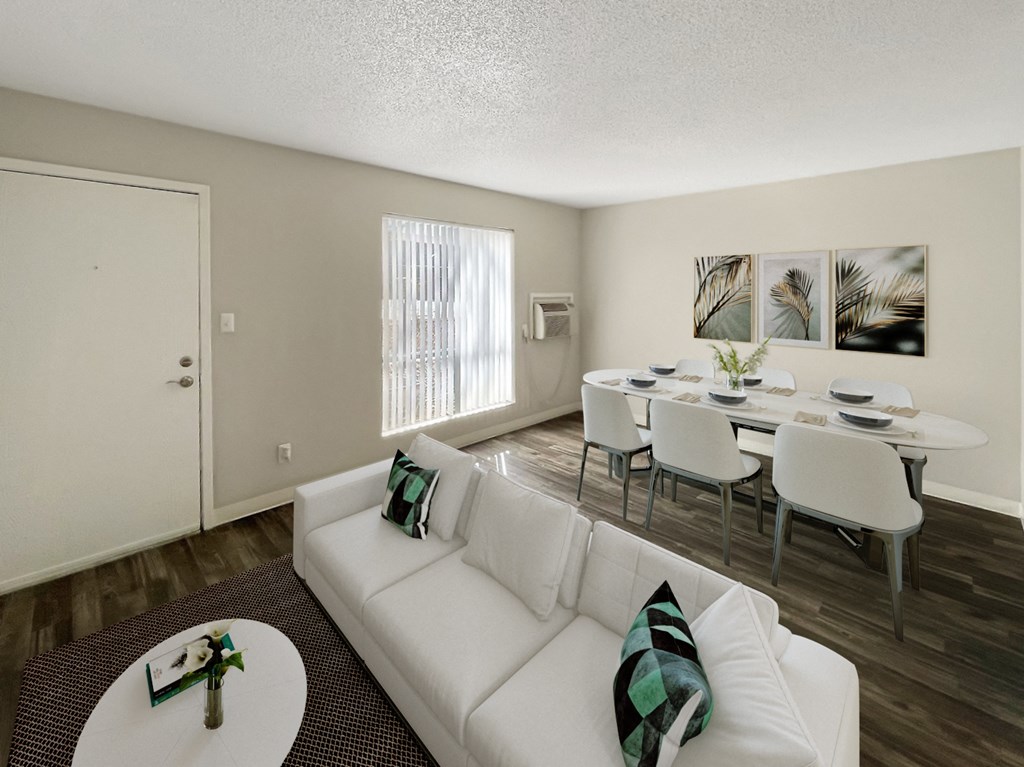 a living room with a white couch and a dining room table
