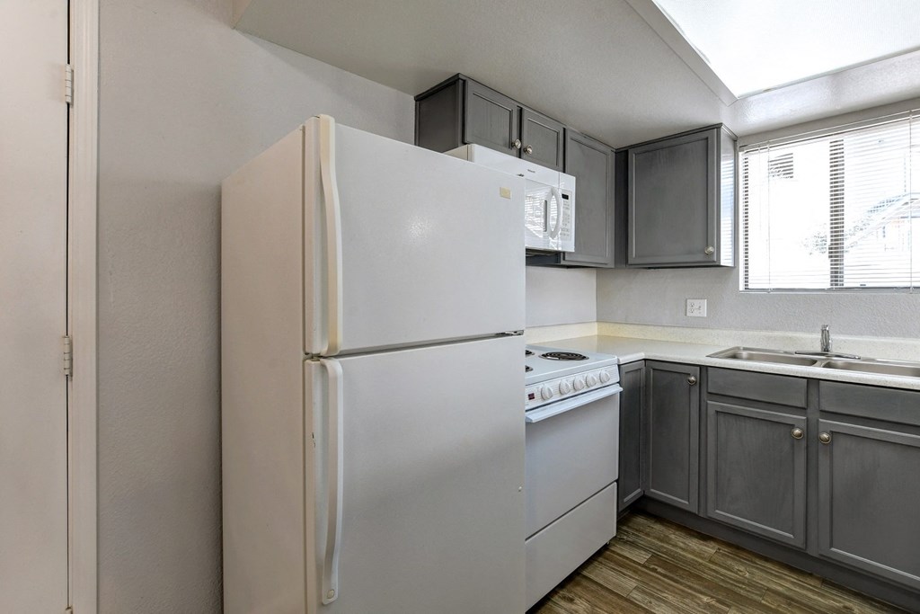 the preserve at ballantyne commons apartment kitchen with white refrigerator and sink
