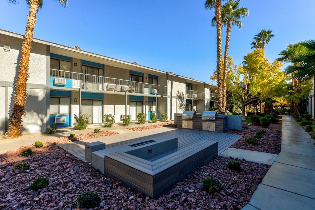 a patio with a hot tub in front of a building