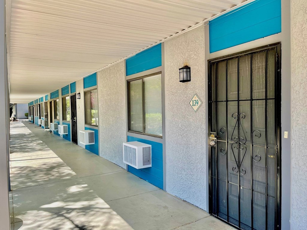 a building with doors and windows and a sidewalk