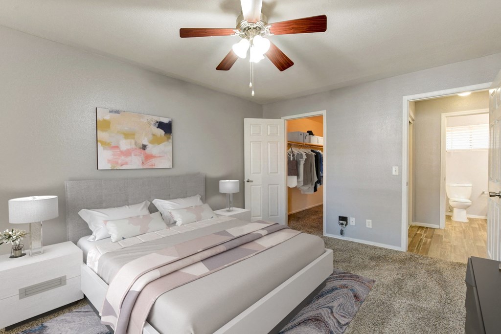 a bedroom with a large bed and a ceiling fan
