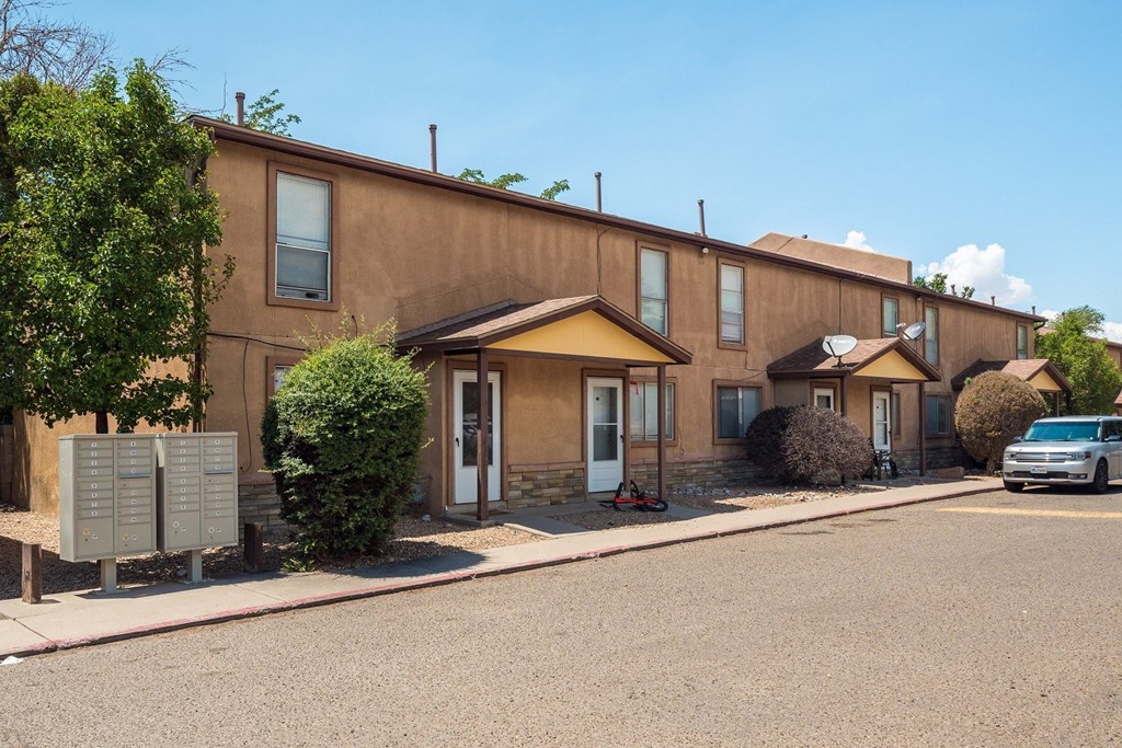 a brown building with a blue sky in the background