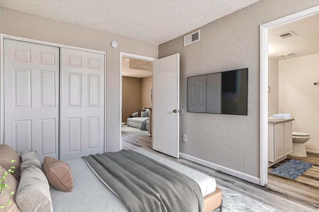 a bedroom with a tv on the wall