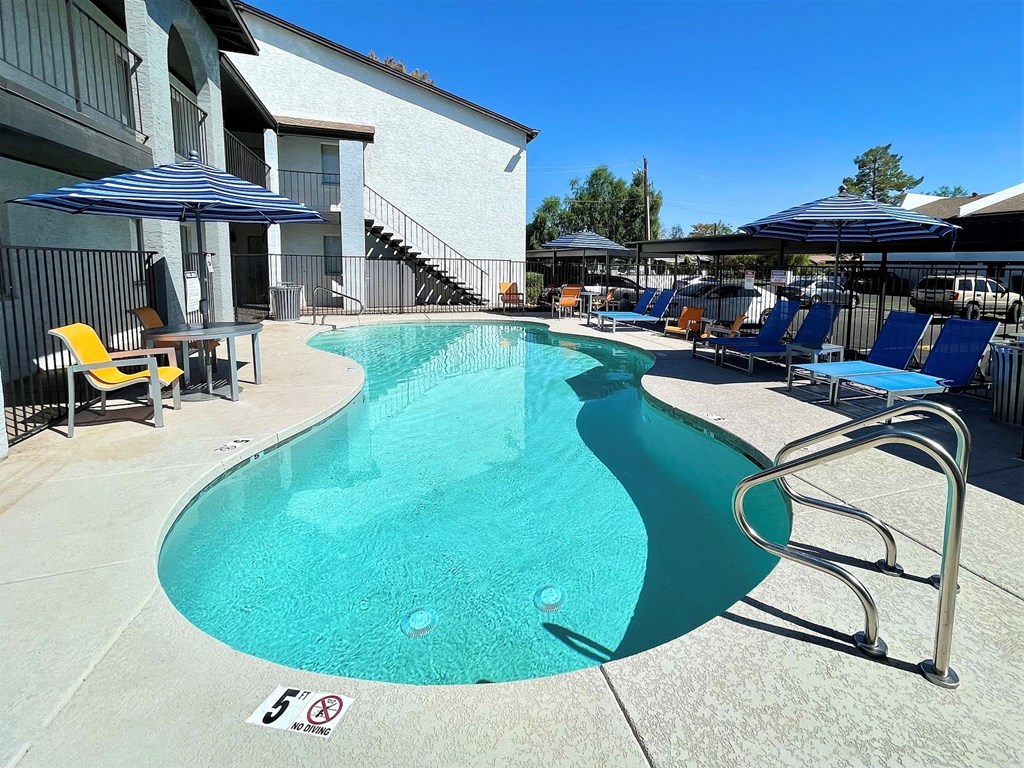 our apartments have a large pool with lounge chairs and umbrellas
