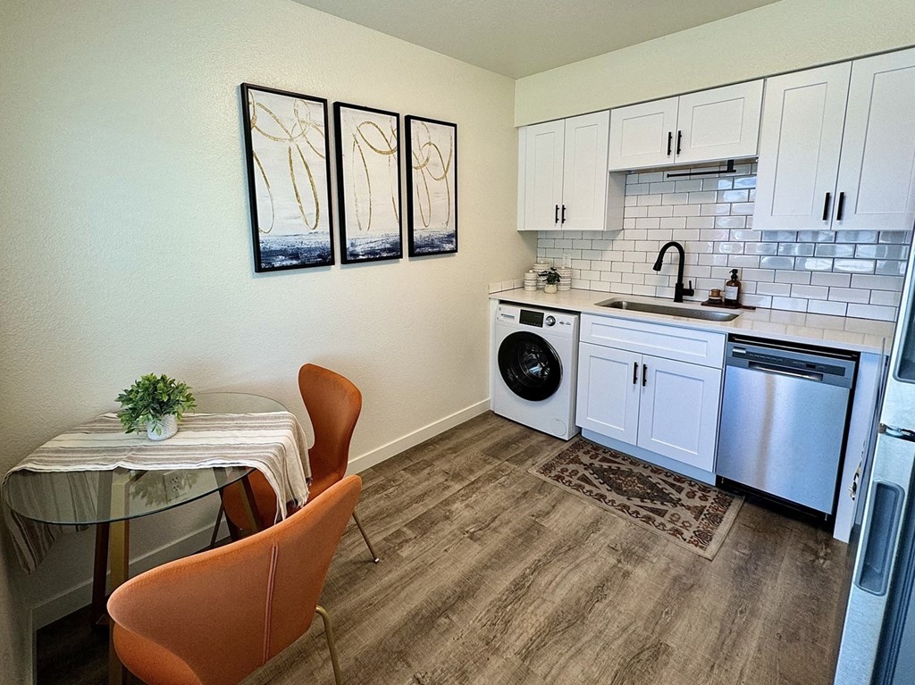 a small kitchen with a table and a washing machine