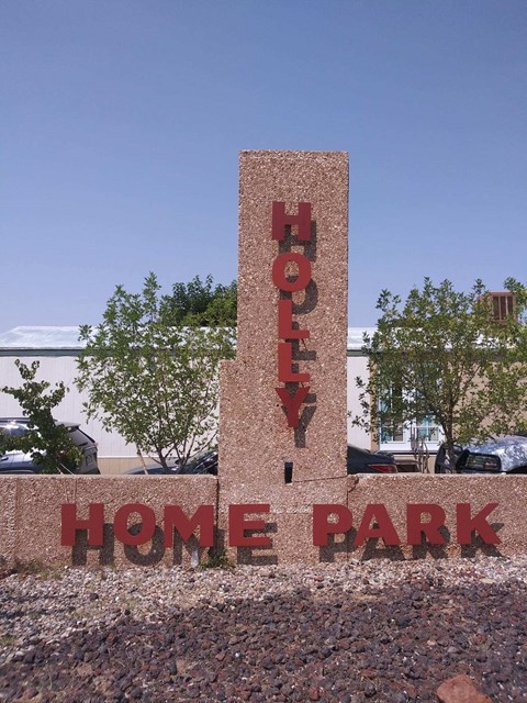 a sign that says home park in front of a building