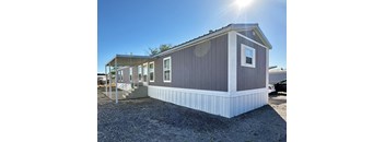 a manufactured home is shown with the sun shining