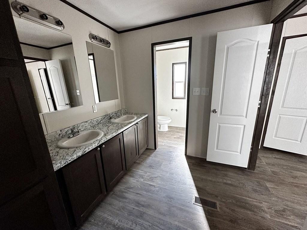 a bathroom with two sinks and a toilet in it