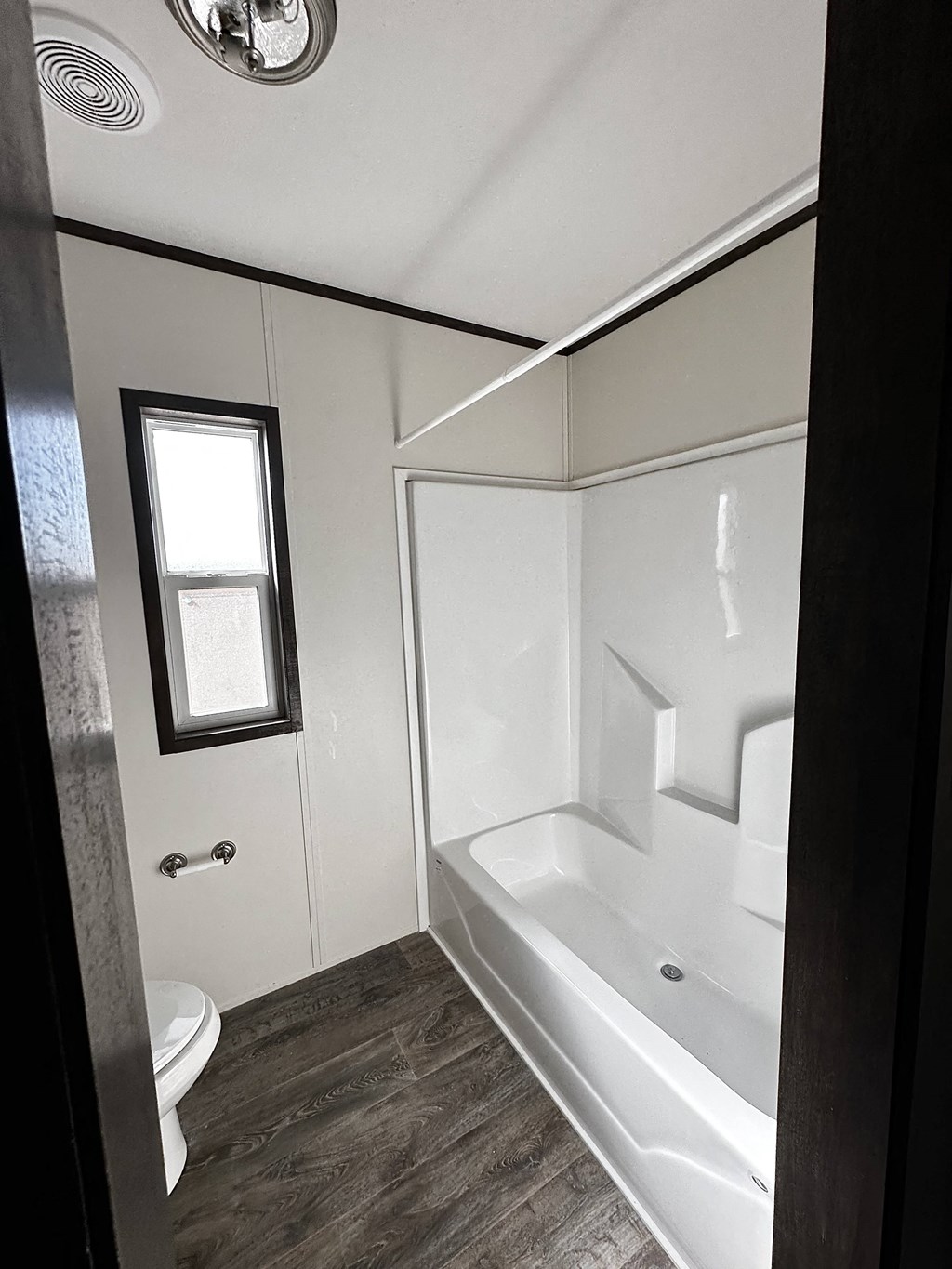 a small bathroom with a tub and a toilet