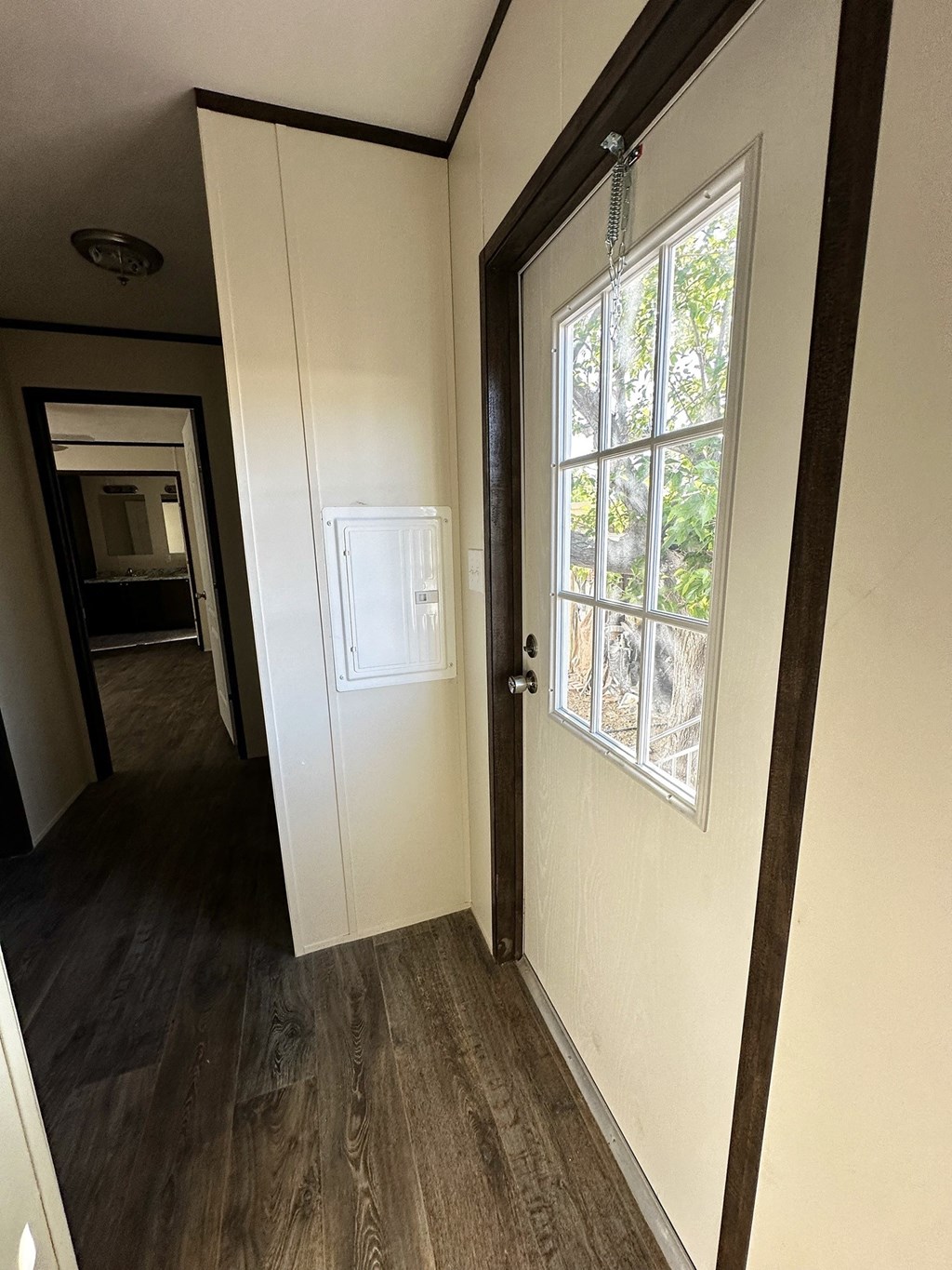 a door with a window in a room with a hallway