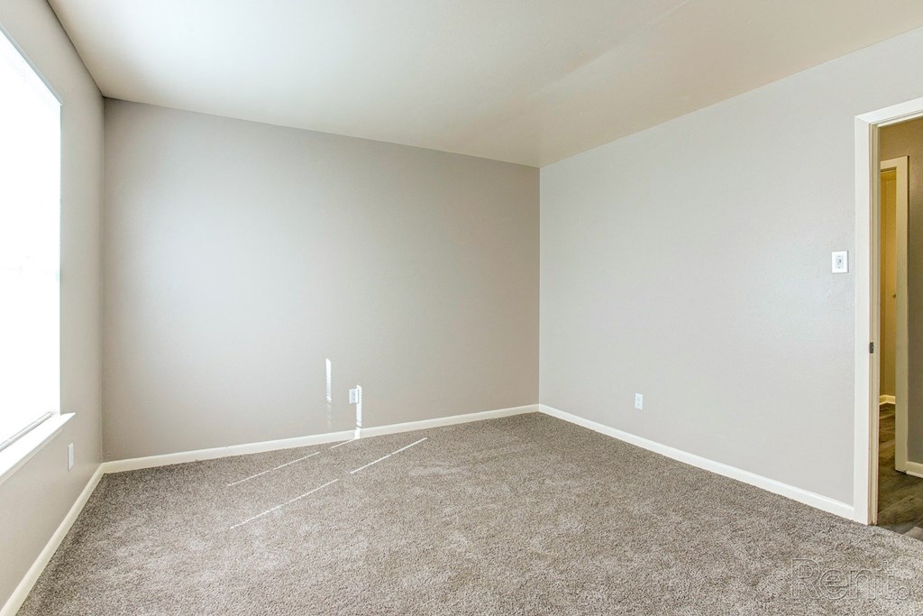 an empty room with carpet and a door