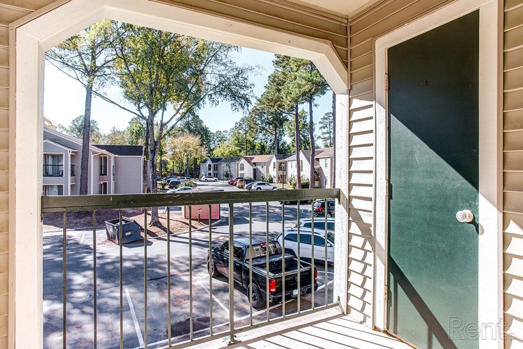 a view of the street from a balcony with a gate