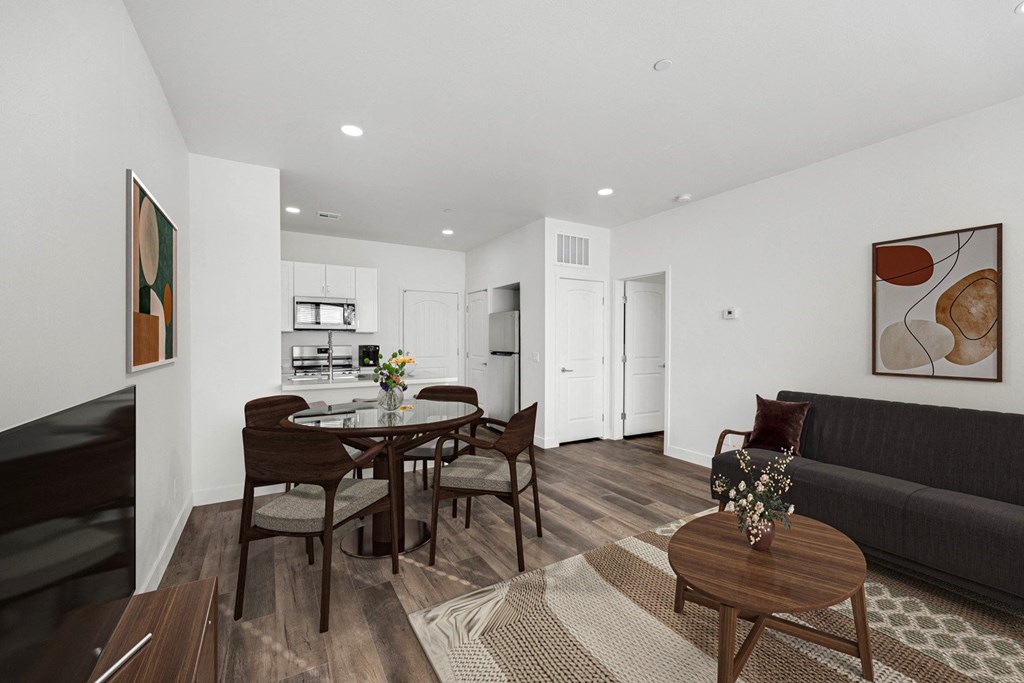 a living room and dining room with a table and chairs