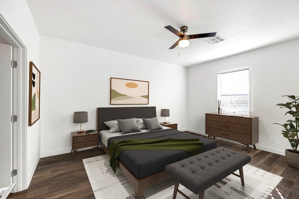 a bedroom with a large bed and a ceiling fan