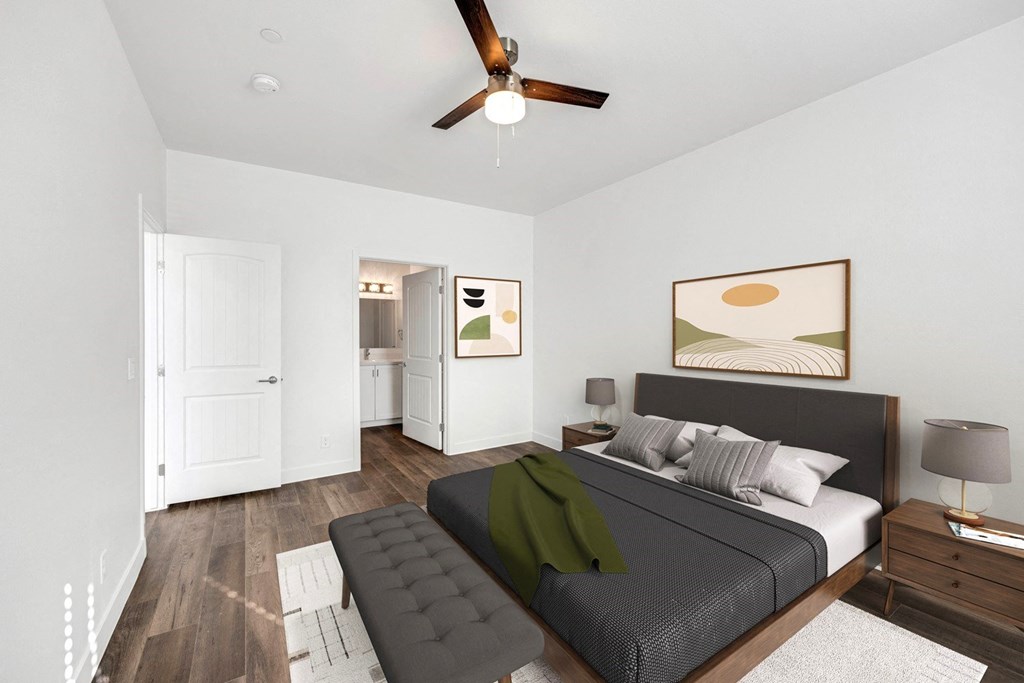a bedroom with a large bed and a ceiling fan