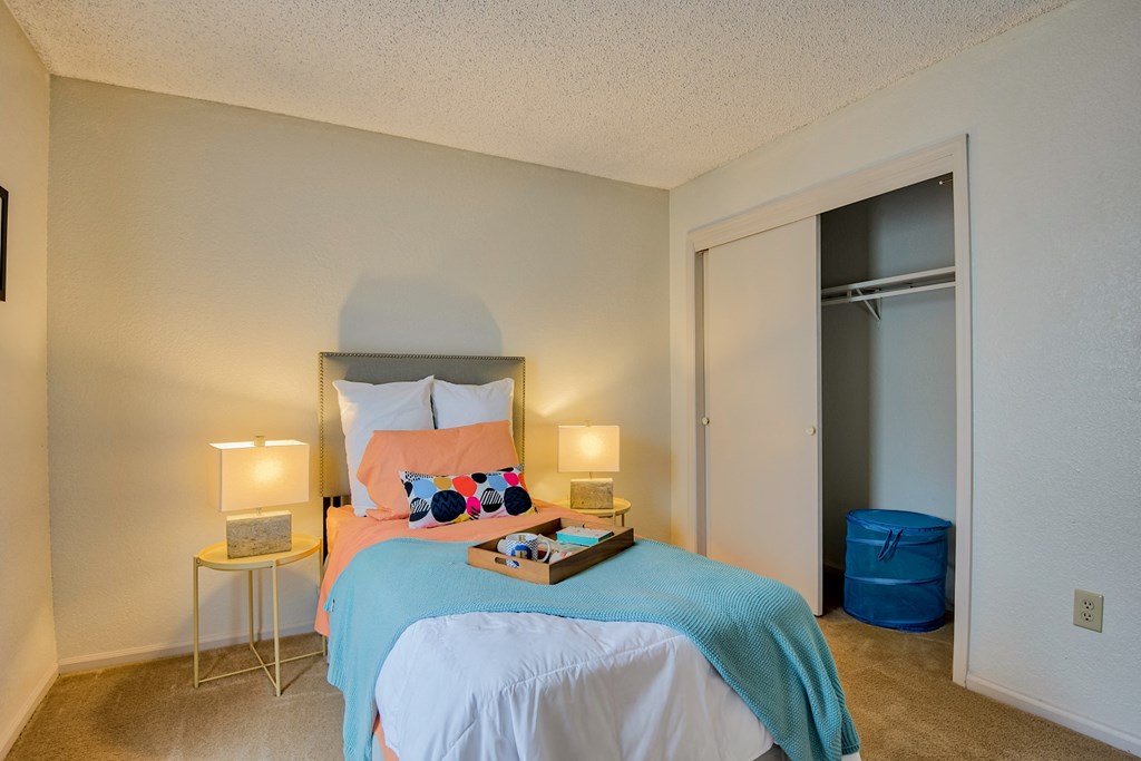 a bedroom with a bed and two night stands