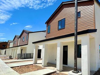a row of houses with a blue sky in the background
