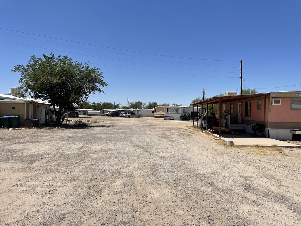 a dirt road with houses on the side of it