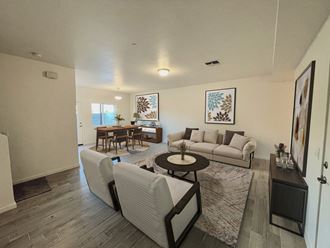a living room with white walls and a wooden floor