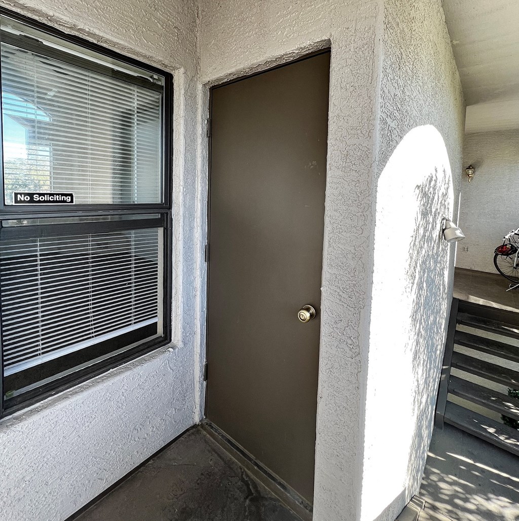 the front door of an apartment building with a metal door