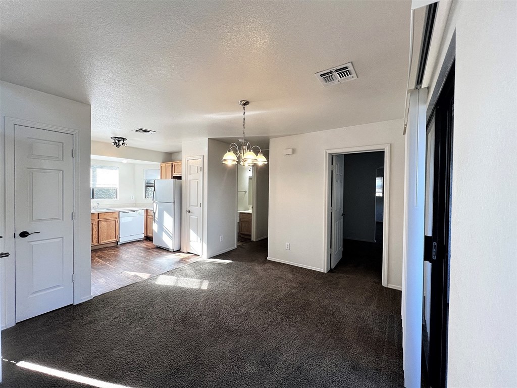 an empty living room and kitchen in a house