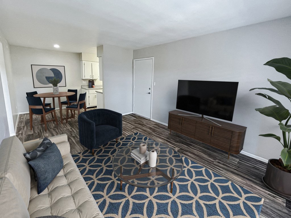 an open living room and dining room with a couch and a tv