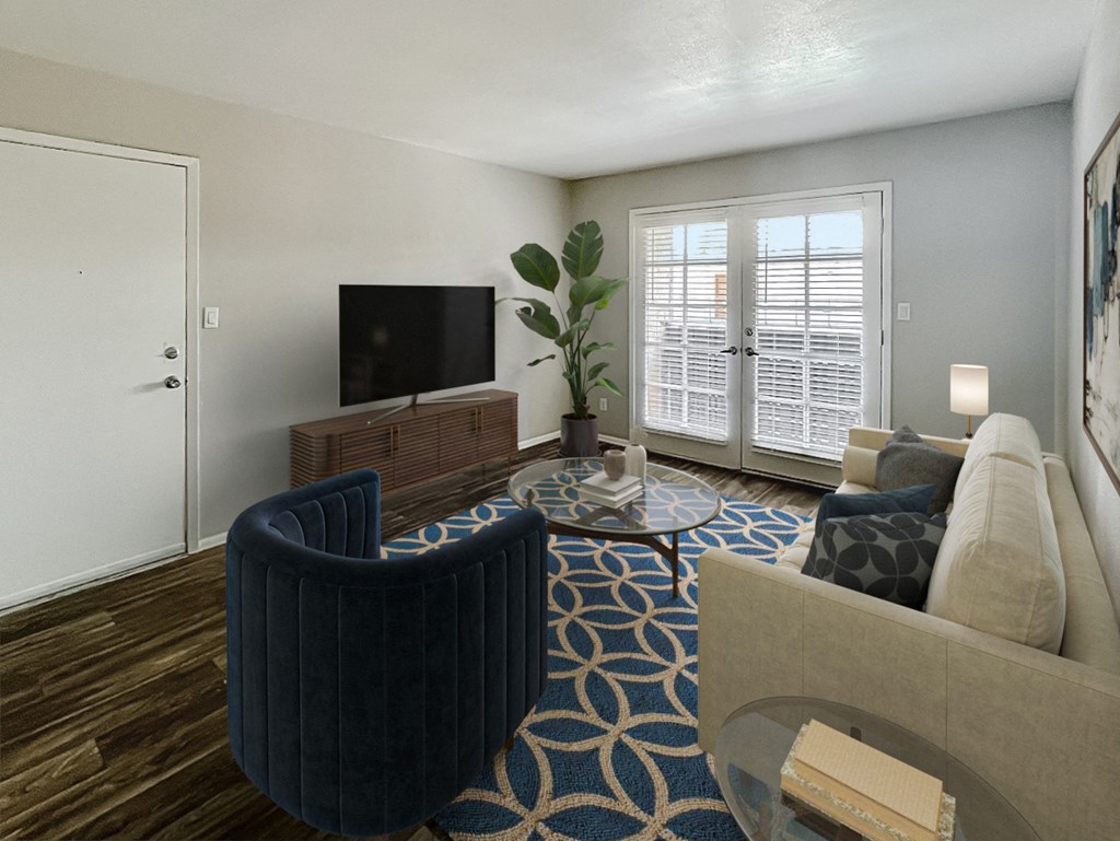 a living room with a couch and a chair and a tv