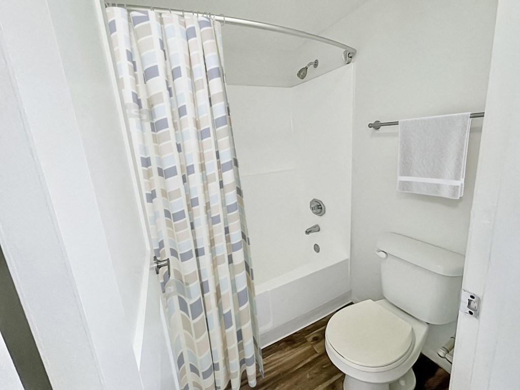 a bathroom with a shower and a toilet in it