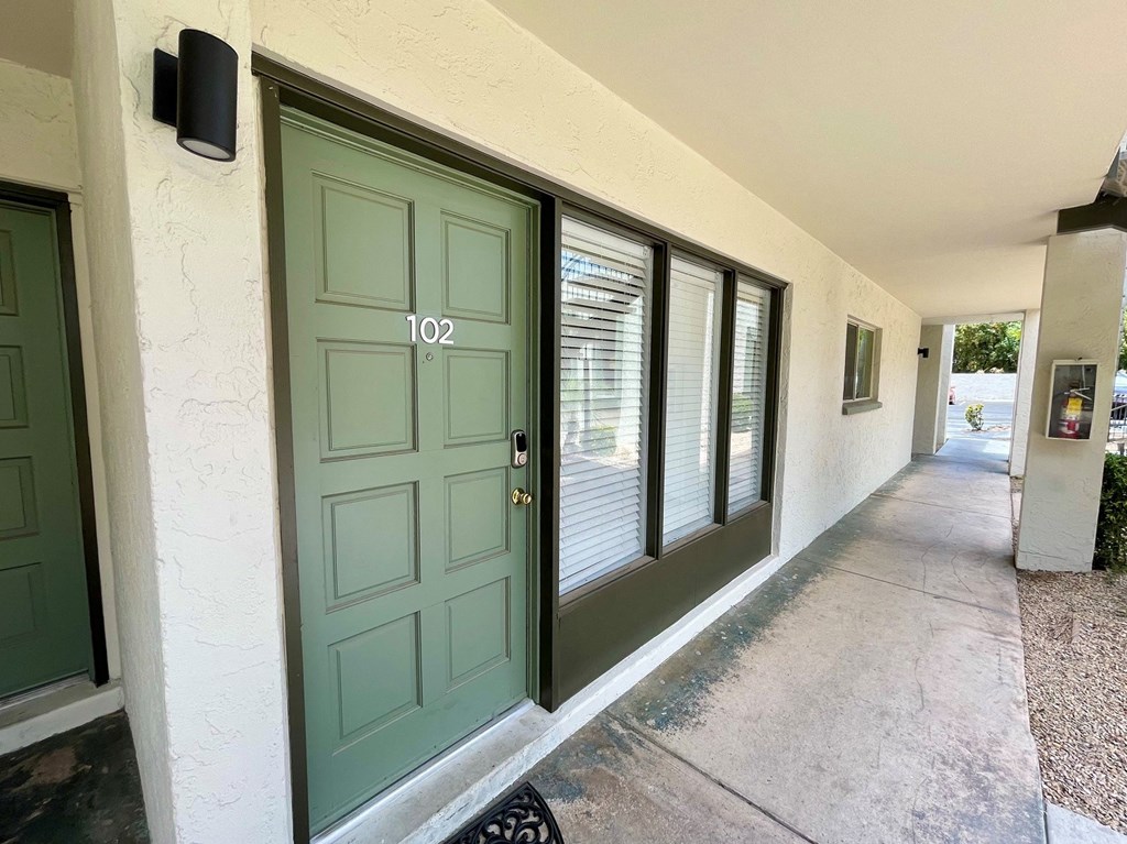 a green door with the number 102 on it